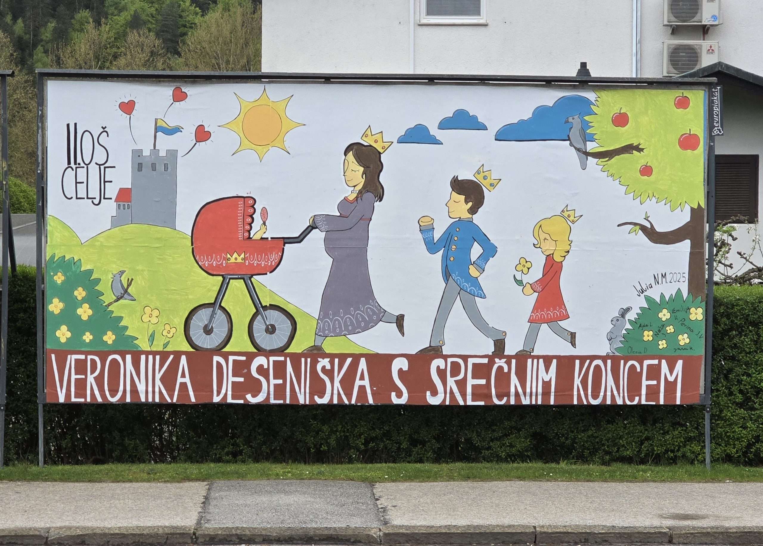 Plakat Urh Jumbo plakat ob cesti. Na njem v koloni korakajo veronika desenjiška in dva otroka.